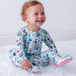 Baby footie pajamas with a Hanukkah-themed print, full-length zipper, and covered feet.