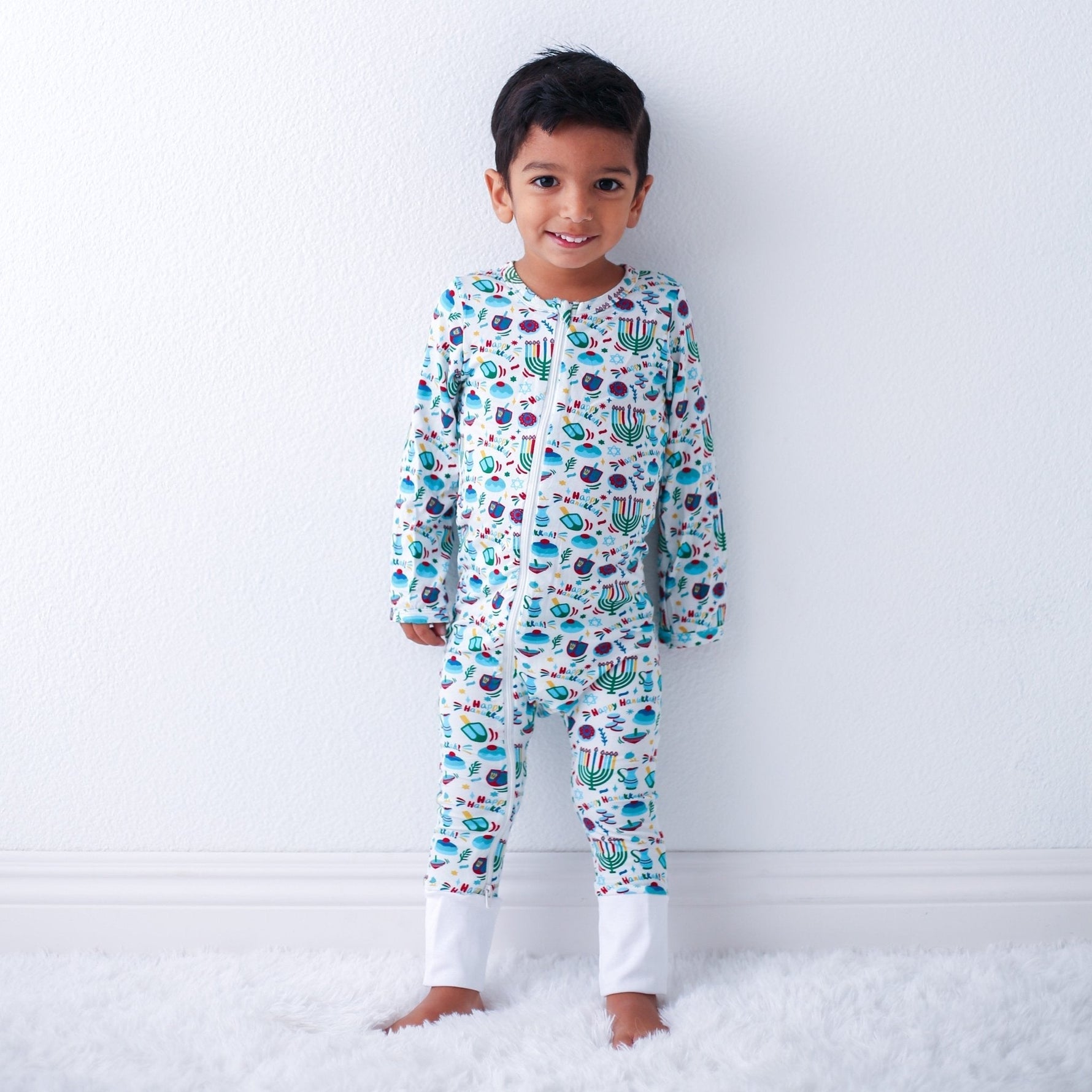 Baby coverall with a Hanukkah-themed print, front zipper, and cuffed ankles