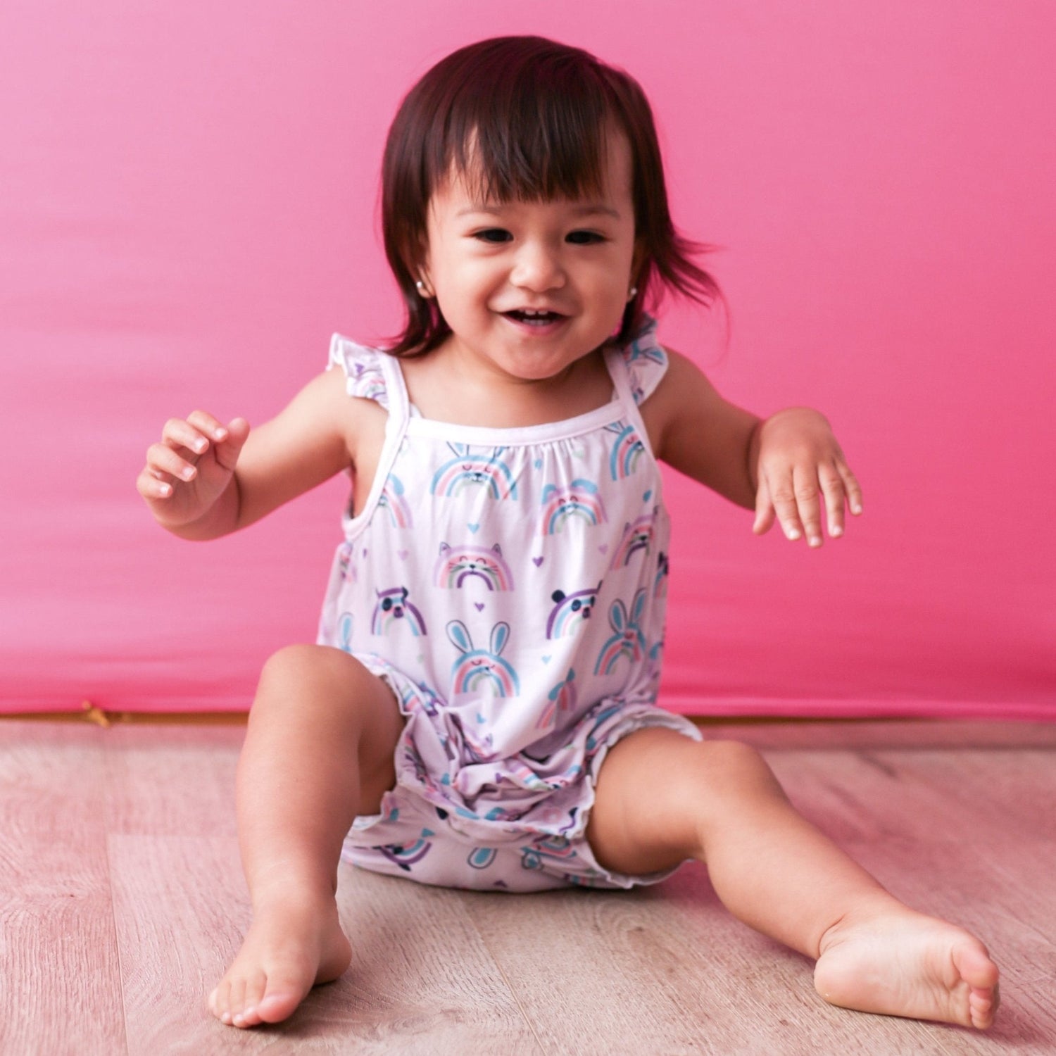 Bubble romper with flutter sleeves in a colorful rainbow print with leg snaps
