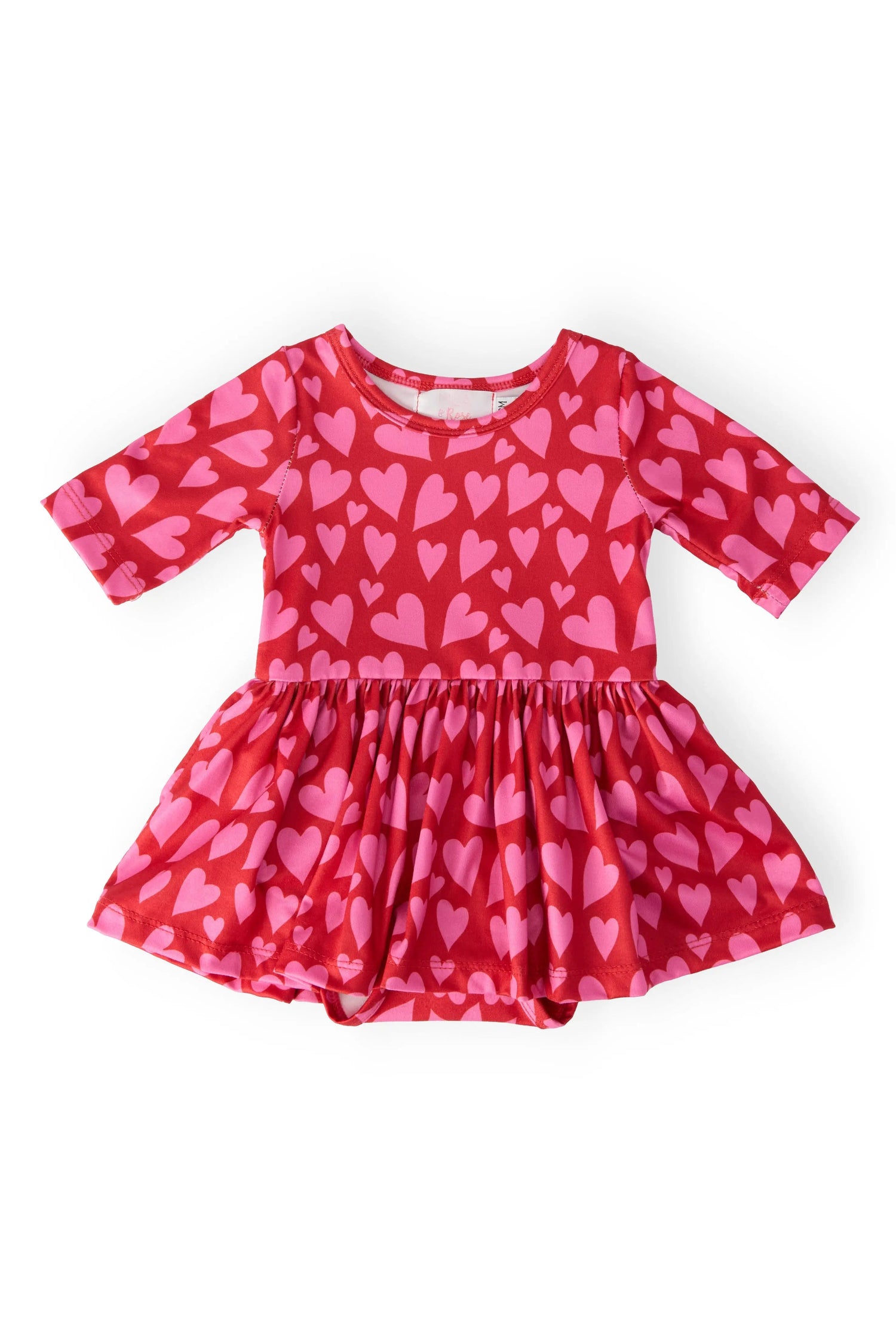 Baby twirl bodysuit with 3/4 sleeves, heart print, and a full twirl skirt over a snap-closure bottom.