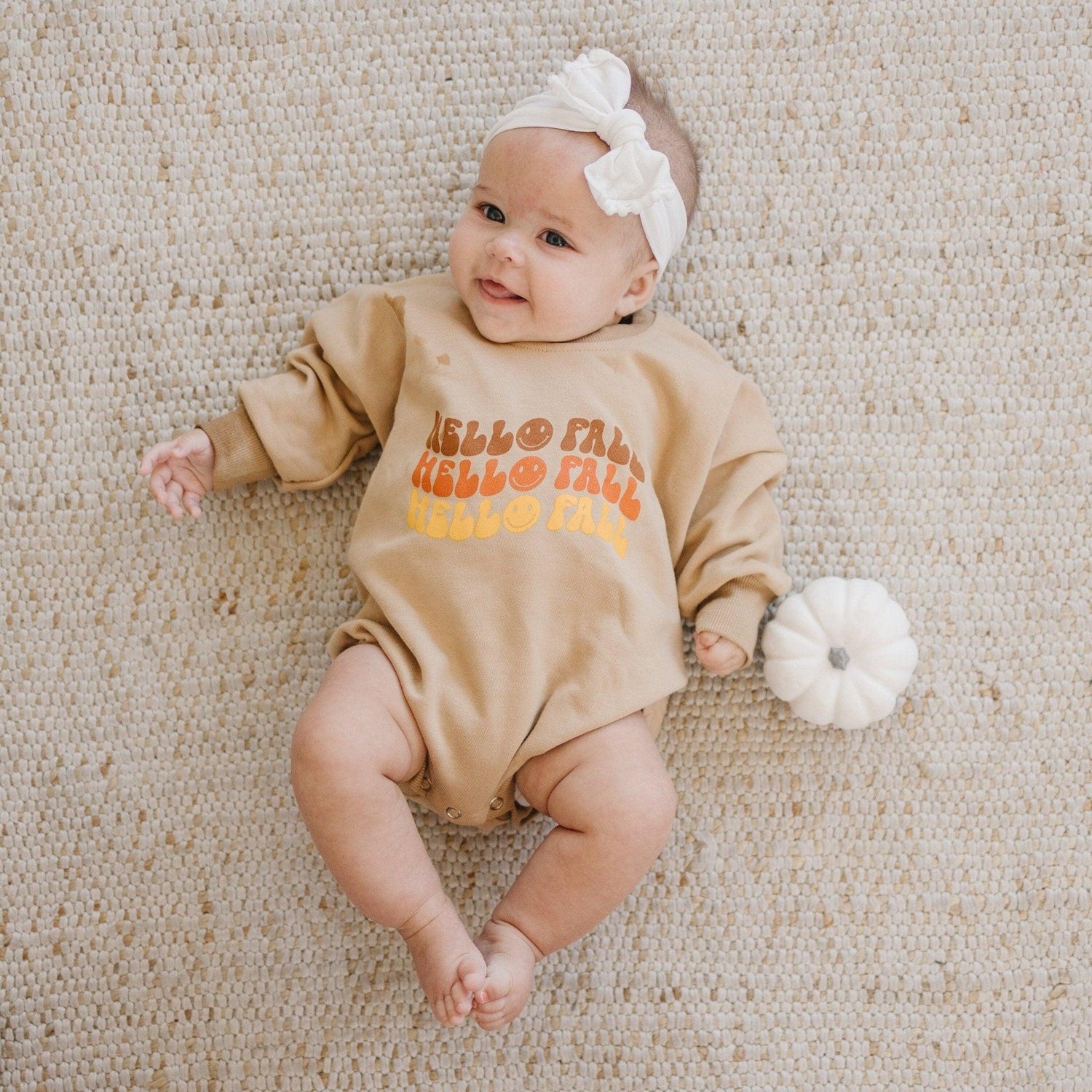 Oversized sweatshirt romper with screenprinted "Hello Fall" graphic and snaps at the crotch