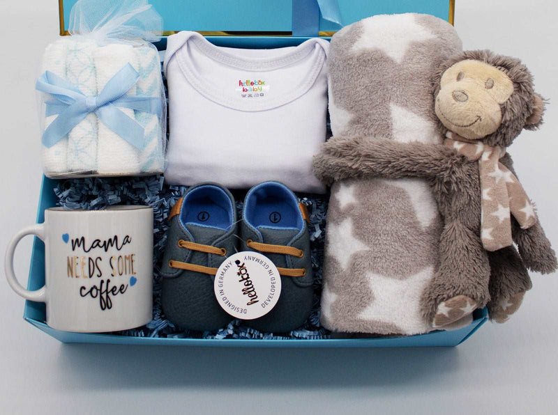 Baby Essential Set with blanket, plush toy, washcloths, walking shoes, onesie, and a mug, perfect gift for newborns.