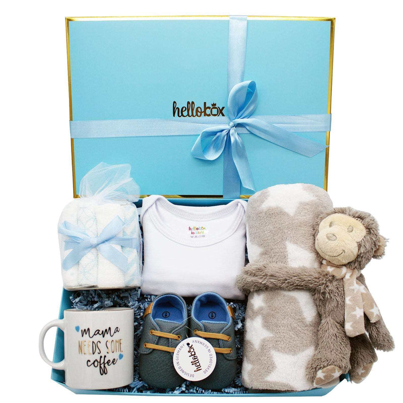 Baby Essential Set gift box with blanket, plush toy, washcloths, baby moccasins, onesie, and mug.