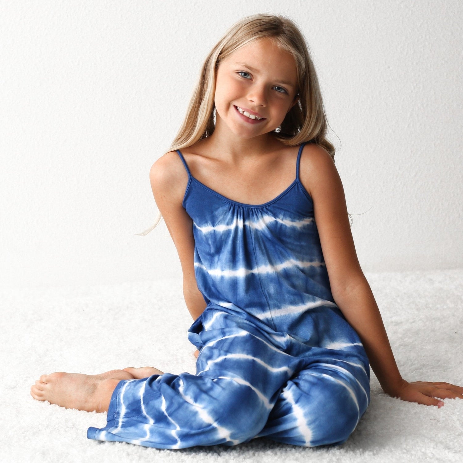 Sleeveless blue and white tie dye jumpsuit with self-tie straps and pockets
