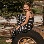 Kids jumpsuit in black, grey, and white tie dye with adjustable self-tie straps and pockets