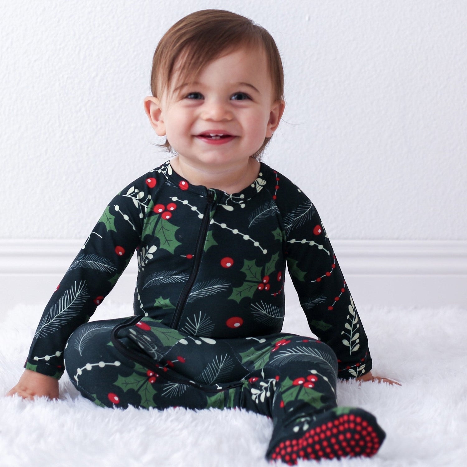 Baby footie pajamas in a Holiday Nights print with full-length front zipper and footed legs.