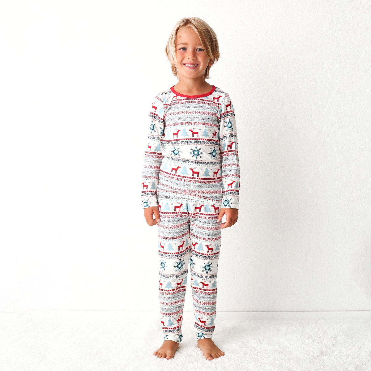Blue two-piece baby pajama set with holiday reindeer print, matching long-sleeve top and pants