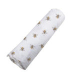 Soft organic bamboo baby swaddle blanket with a charming honey bee print, folded neatly.