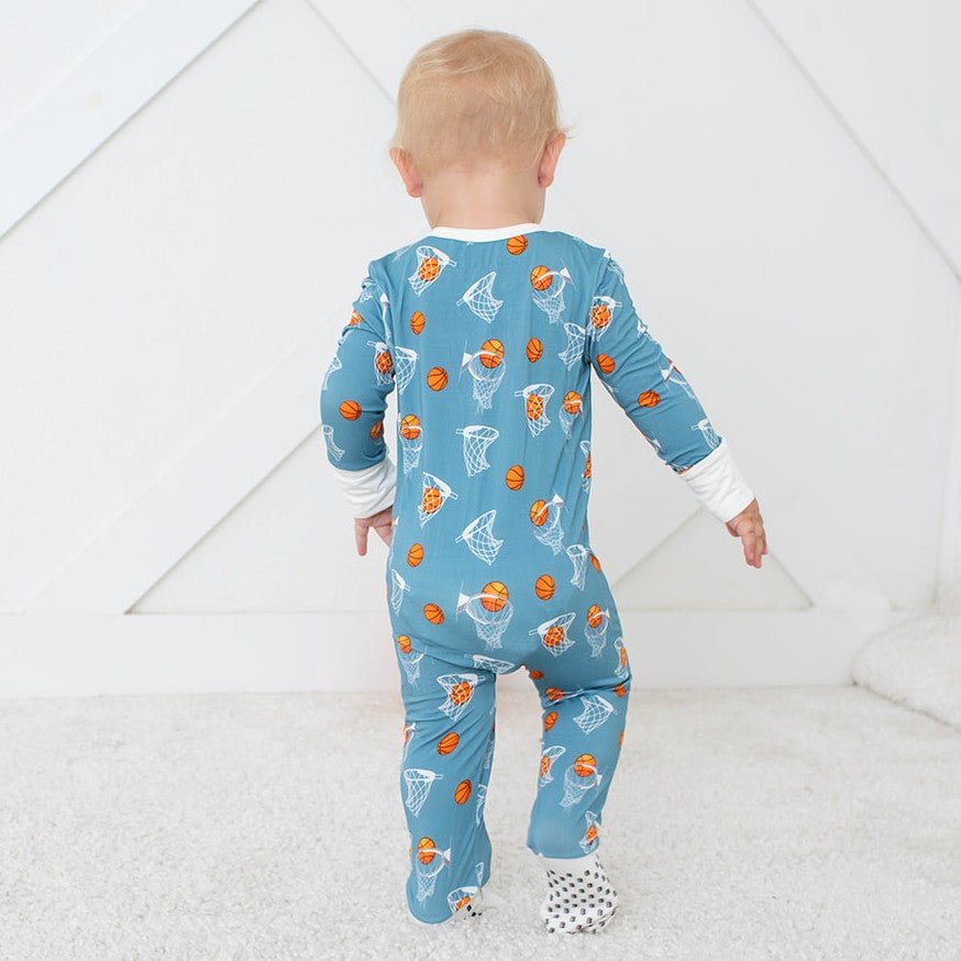 Convertible coverall with a basketball hoops print and full-length two-way zipper, footed style