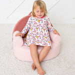 Long-sleeve toddler dress with a bright print of owls and flowers