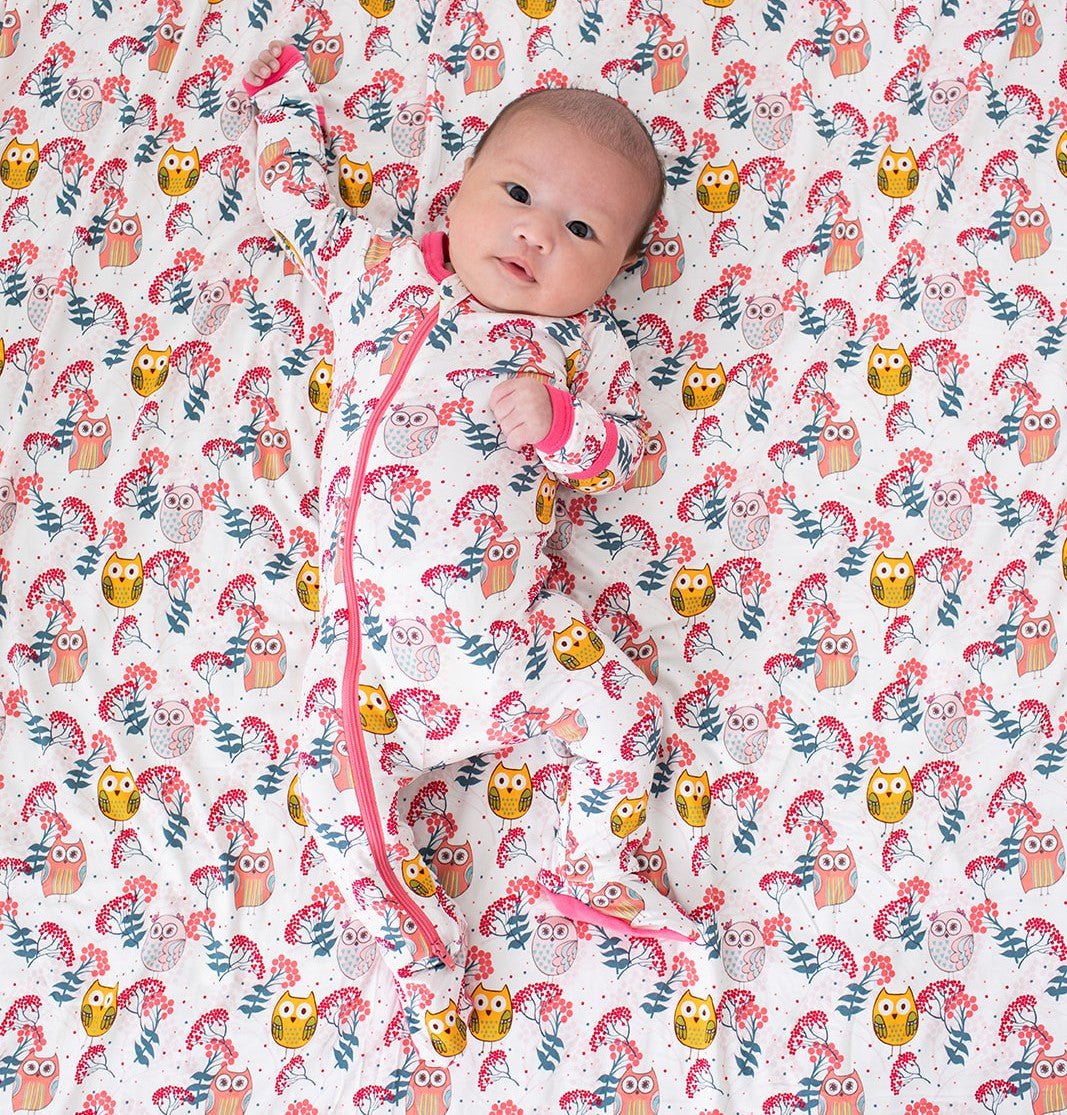 Baby footie pajamas with an owl and floral print and a full-length front zipper