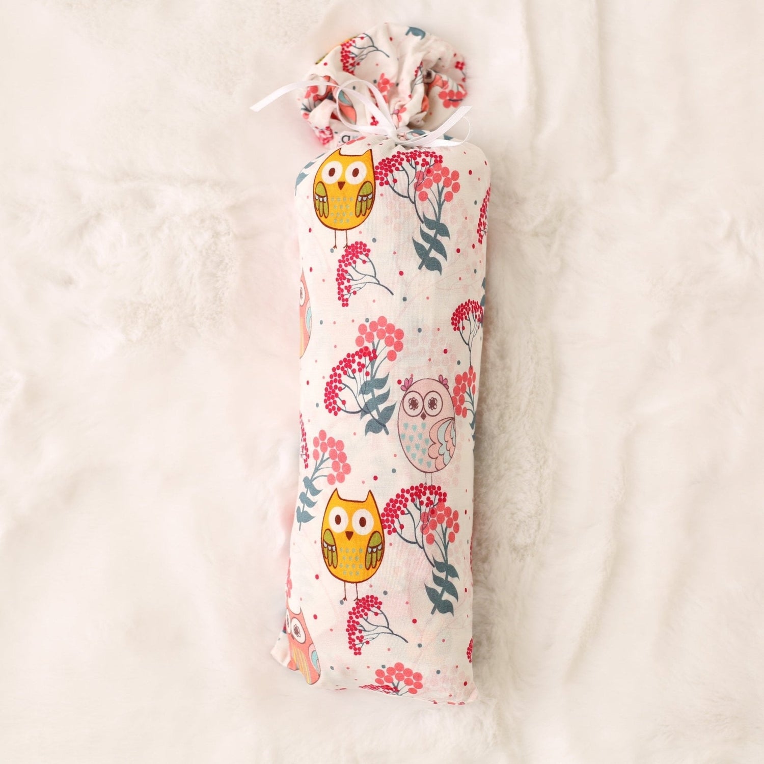 Large square baby swaddle blanket with a great horned owl and floral pattern.