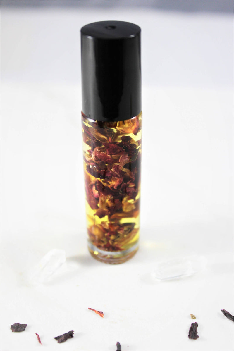 Organic perfume oil in a glass bottle with rose petals, offering a natural, non-toxic fragrance solution.