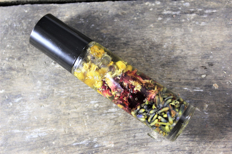 Organic essential oil perfume blend with lavender, vanilla, and patchouli in a roll-on bottle.