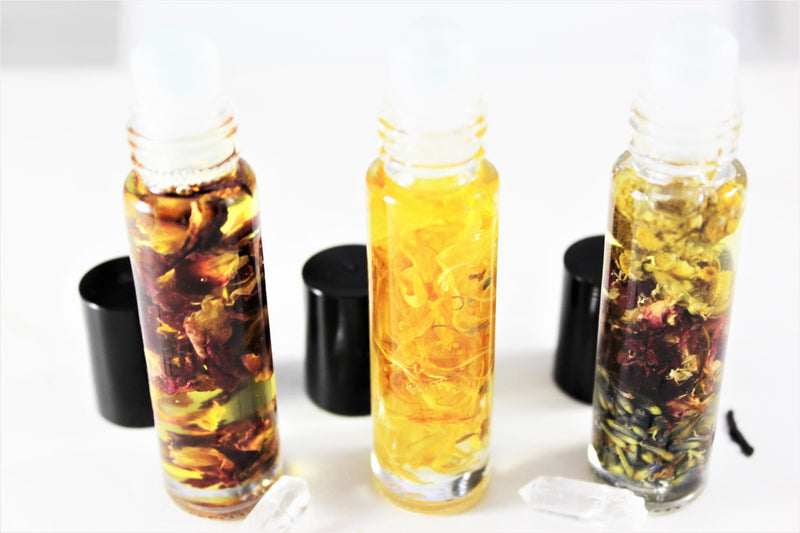 Organic perfume oil in glass bottles with organic rose petals, cruelty-free essential oil blend.