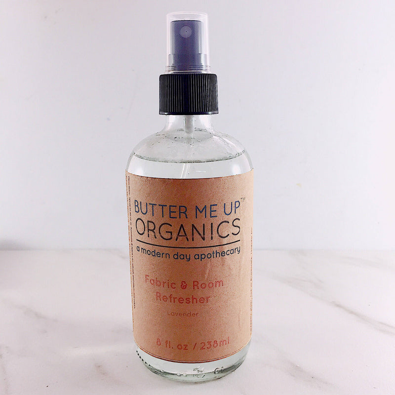 Organic fabric and room deodorizer spray with essential oils, shown in a clear bottle.