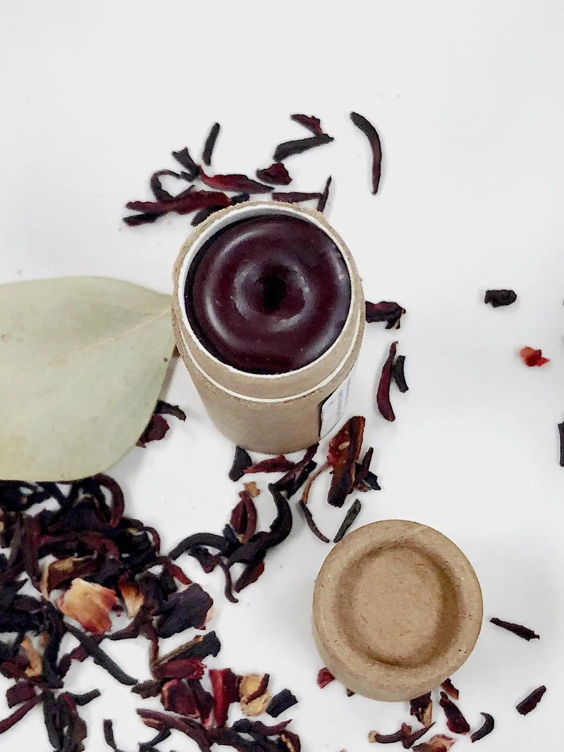 Organic natural cheek and lip stain in eco-friendly paperboard tube with dried herbs.