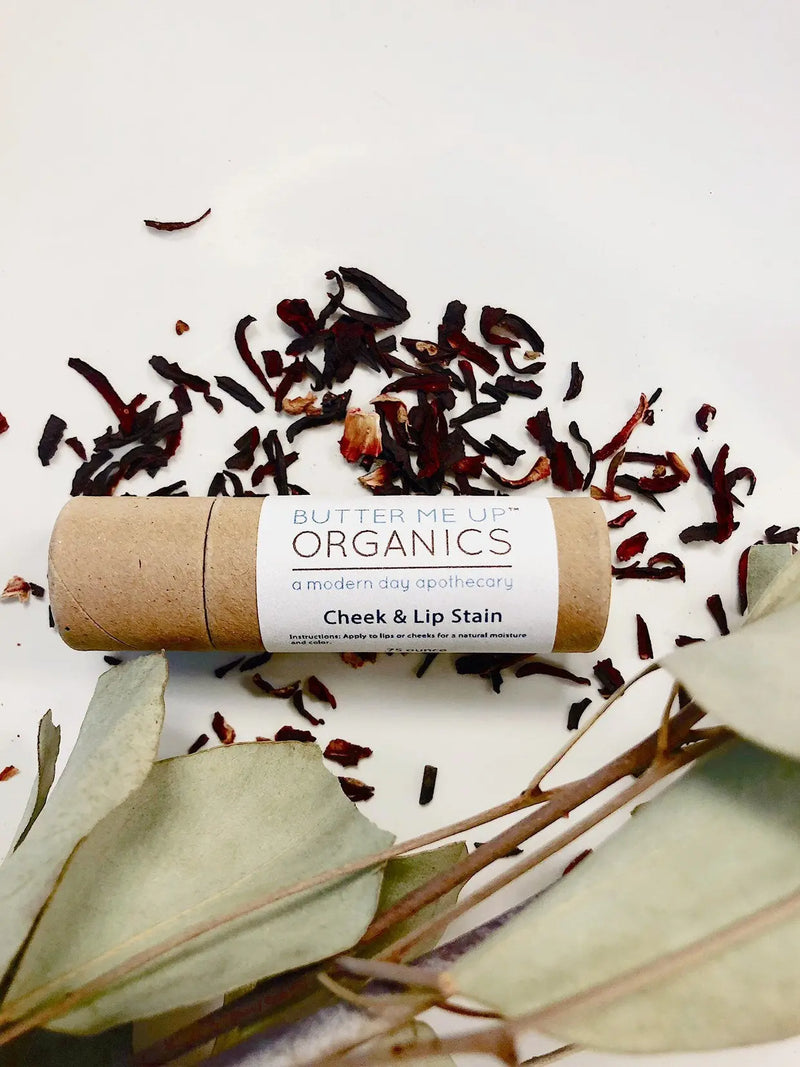 Organic natural cheek and lip stain in eco-friendly paperboard tube with dried botanicals.