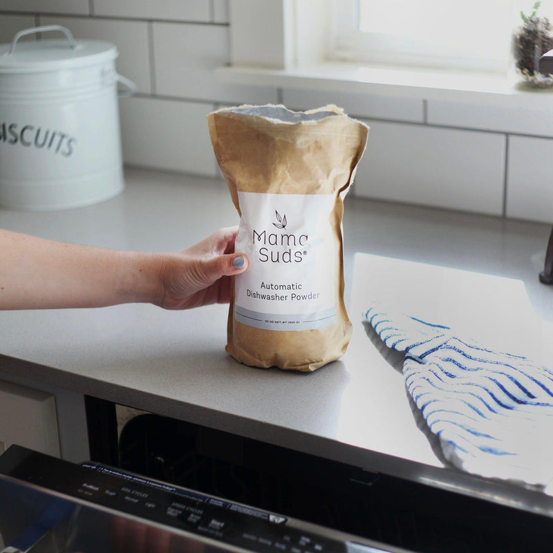 Nontoxic and eco-friendly MamaSuds Automatic Dishwasher Powder on kitchen counter.