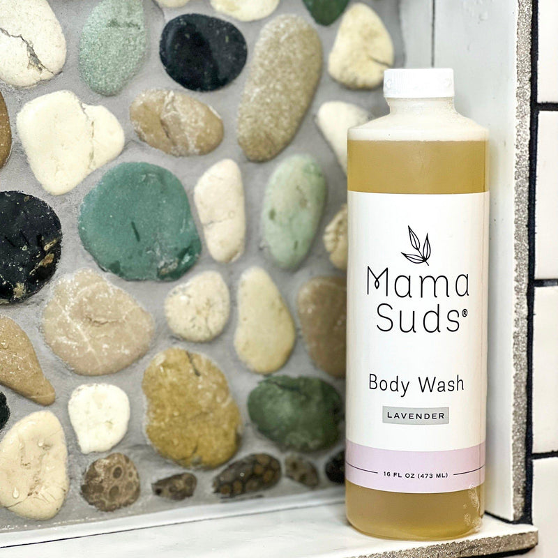 MamaSuds Body Wash Soap, lavender scented, 16 oz bottle on a stone background.