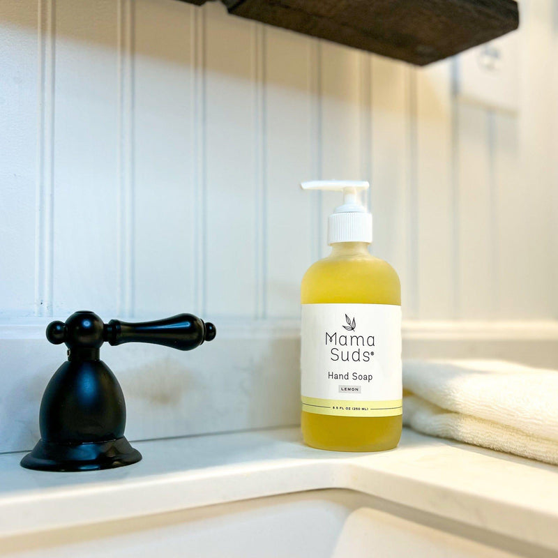 Hand Soap in a glass bottle on bathroom counter.