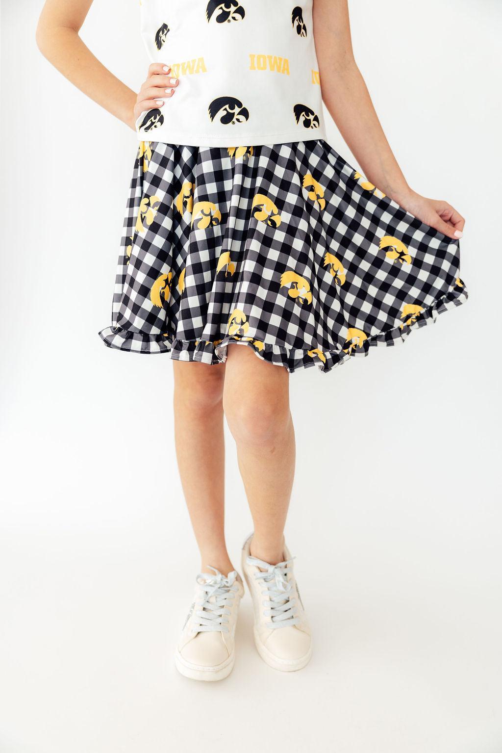 Girls' twirl skort in black and gold Iowa plaid with a Tigerhawk print