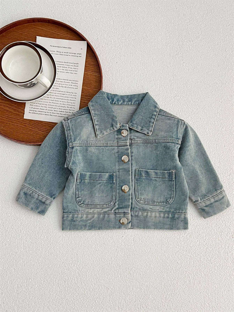 Kids button front washed style denim jacket with turned-down collar displayed on a white surface.