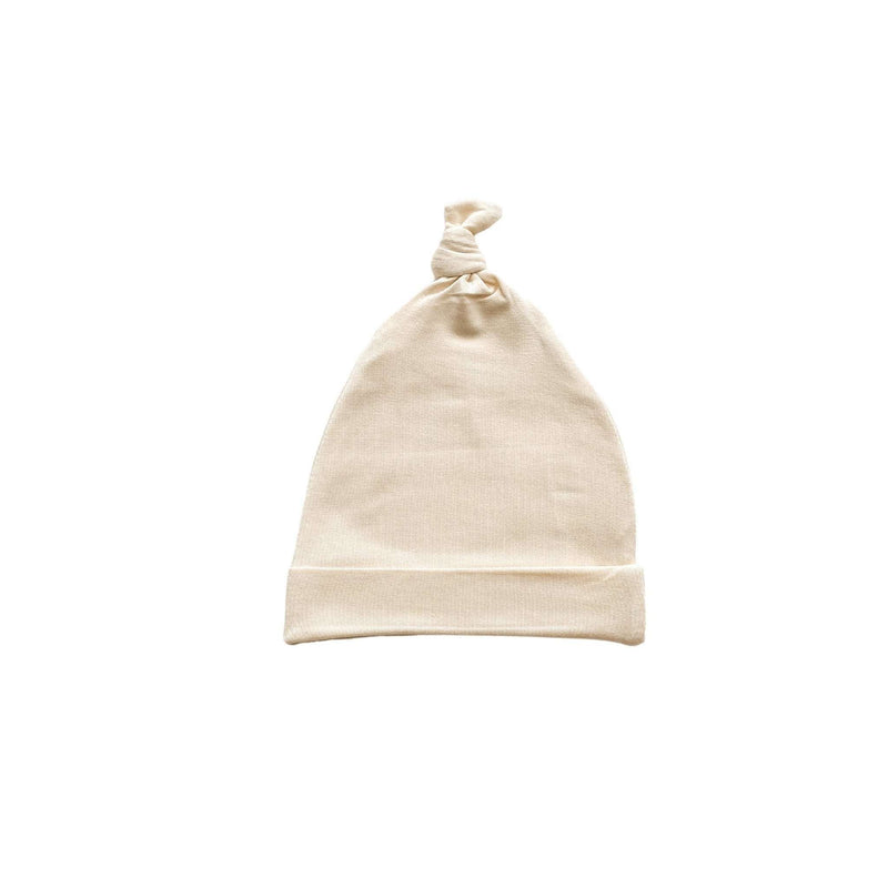 Cream knot hat for newborns, made from soft viscose and spandex, fits up to 3 months.