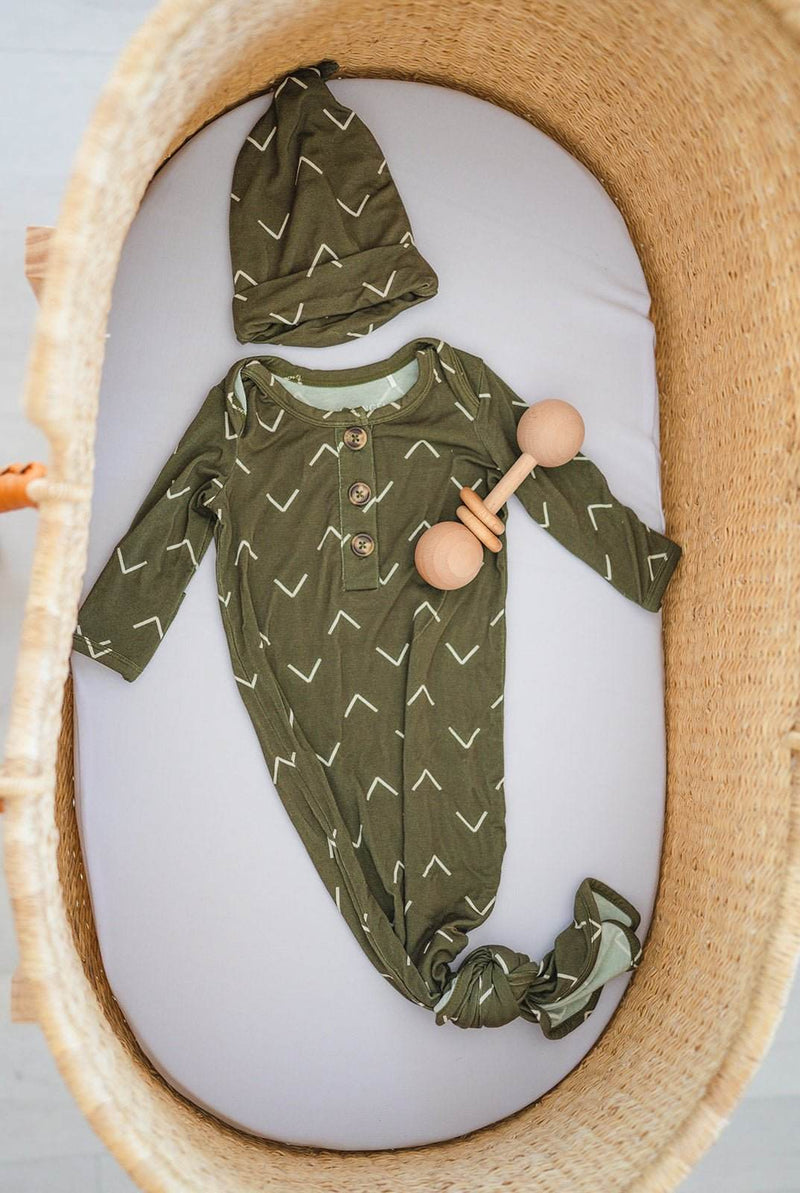 Knot Hat - Green Arrow in bamboo viscose and spandex, one size fits newborn to 3 months, displayed in a cozy setting.