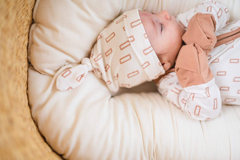 Soft bamboo baby knot hat with neutral rectangle pattern for newborns to 3+ months.