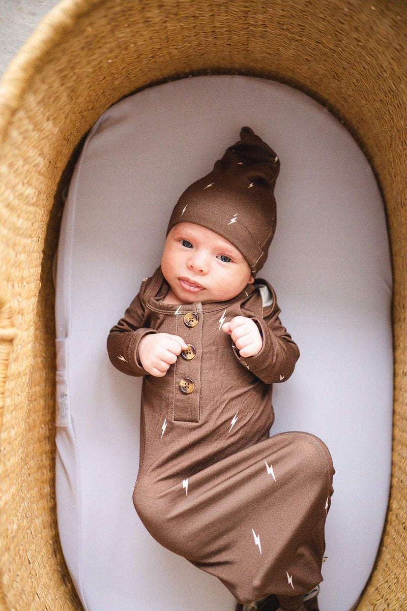 Knotted baby gown in brown lightning design with fold-over cuffs for babies 0-3 months.