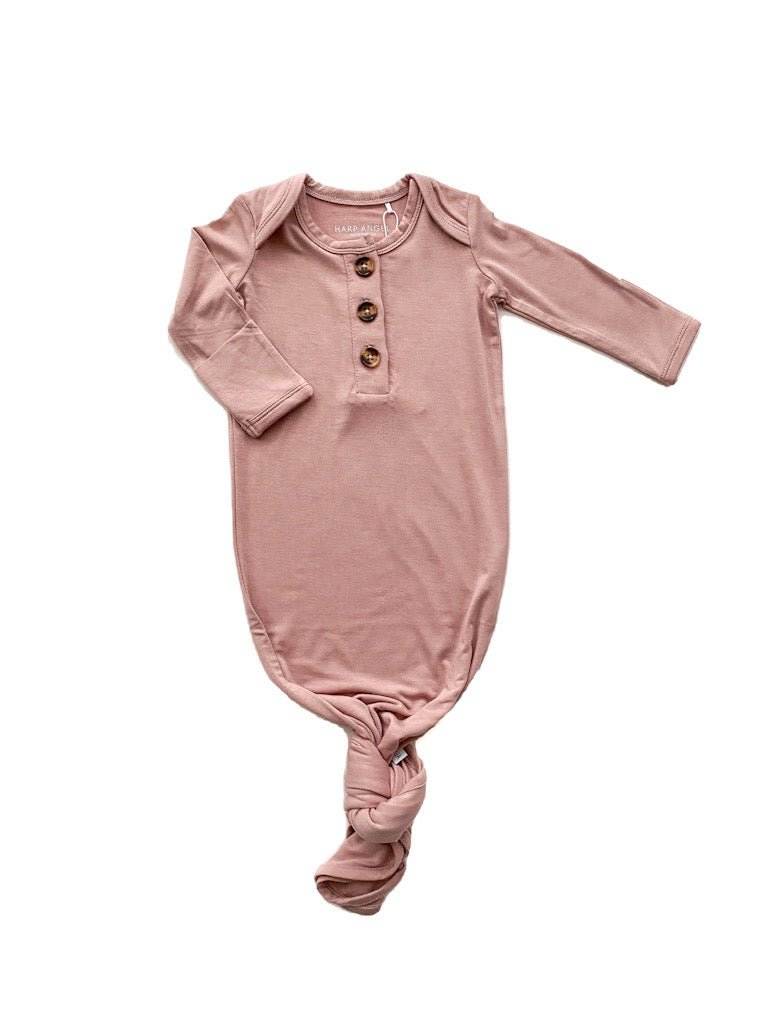 Dusty pink knotted baby gown made from soft bamboo viscose, featuring buttons and fold-over cuffs.