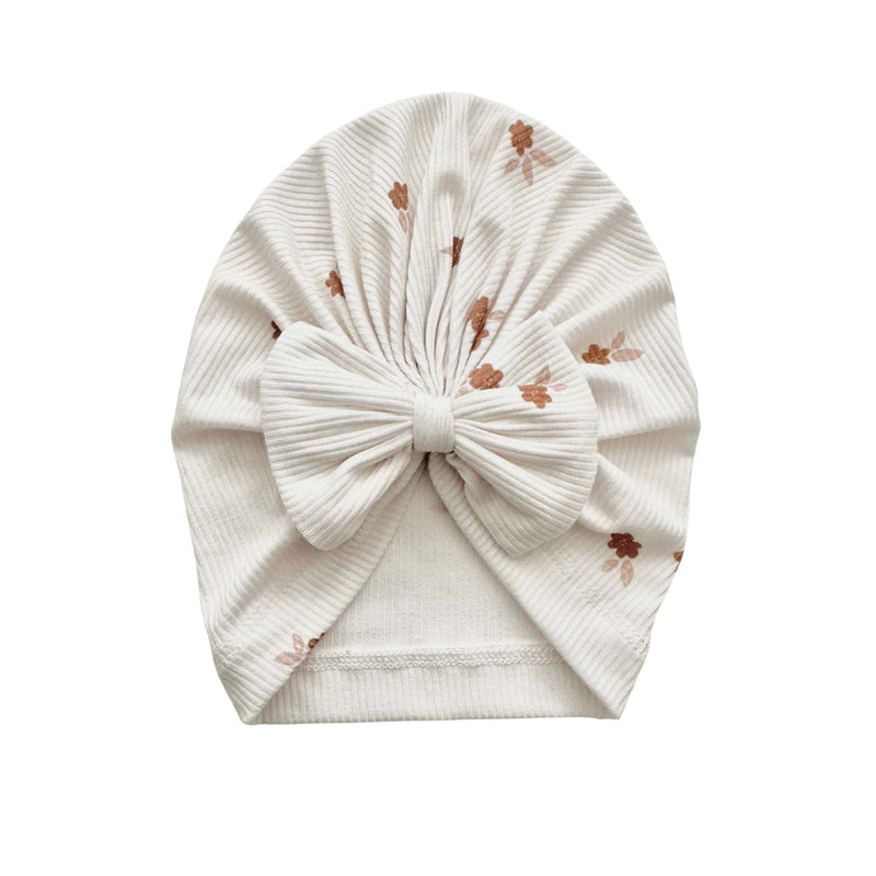 Knotted baby gown in floral design made from soft bamboo material, ideal for infants.