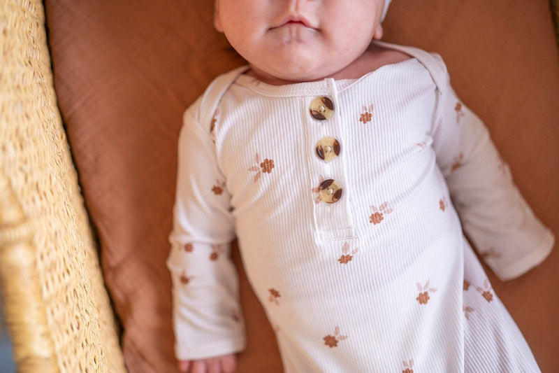 Knotted baby gown in floral print, bamboo viscose material, with fold over cuffs for comfort.