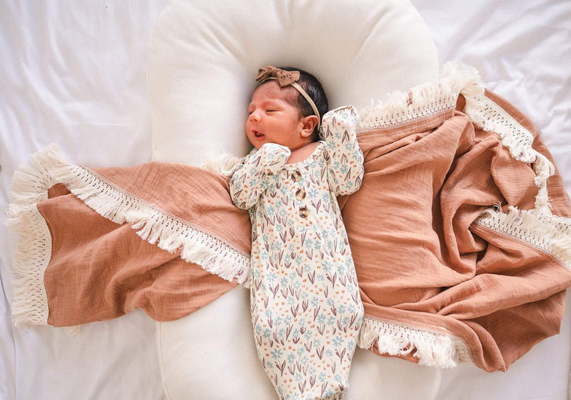 Knotted baby gown in La La Floral bamboo viscose, perfect for comfort and easy diaper changes.