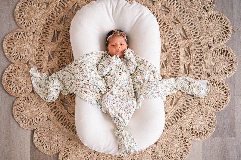 Knotted baby gown in La La Floral print made from soft bamboo viscose, featuring fold-over cuffs and a knotted bottom, perfect for newborn comfort.