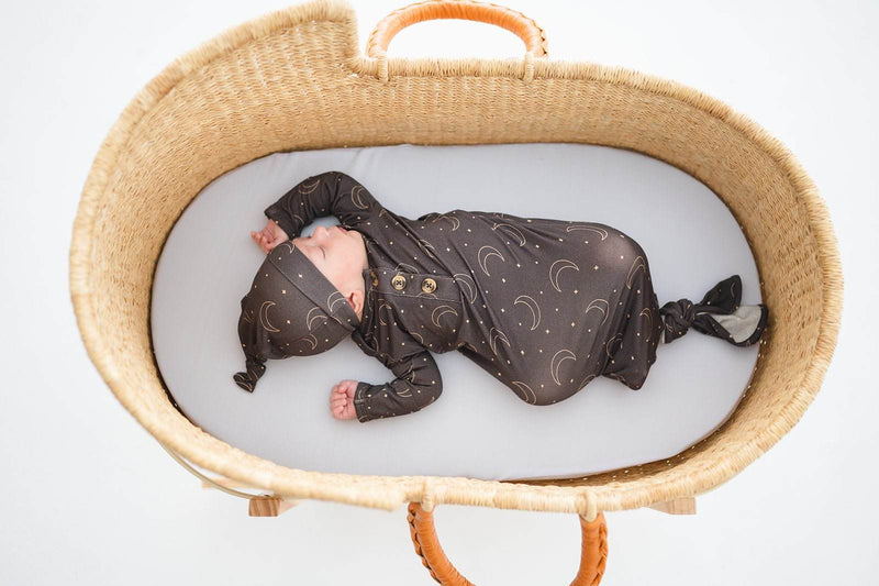 Knotted baby gown in Midnight Moon pattern, made from soft bamboo viscose, featuring fold-over cuffs and a knotted bottom for easy diaper changes.