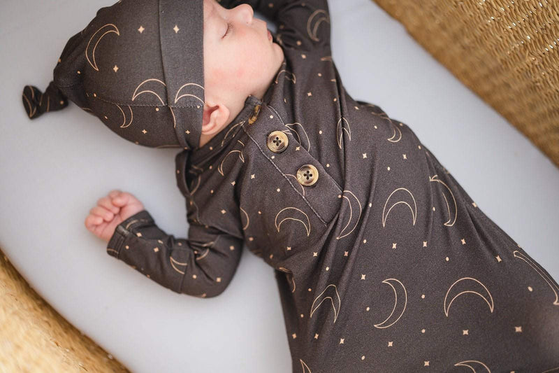 Knotted Baby Gown - Midnight Moon made from bamboo viscose, featuring moon and star design, fold over cuffs, and knotted bottom for easy diaper changes.
