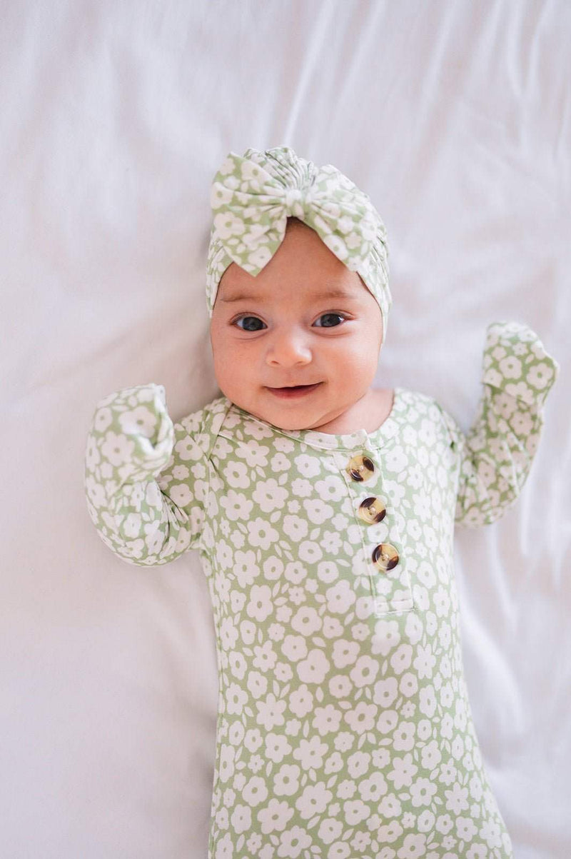 Knotted baby gown in sage ditsy floral pattern with fold-over cuffs for infants.