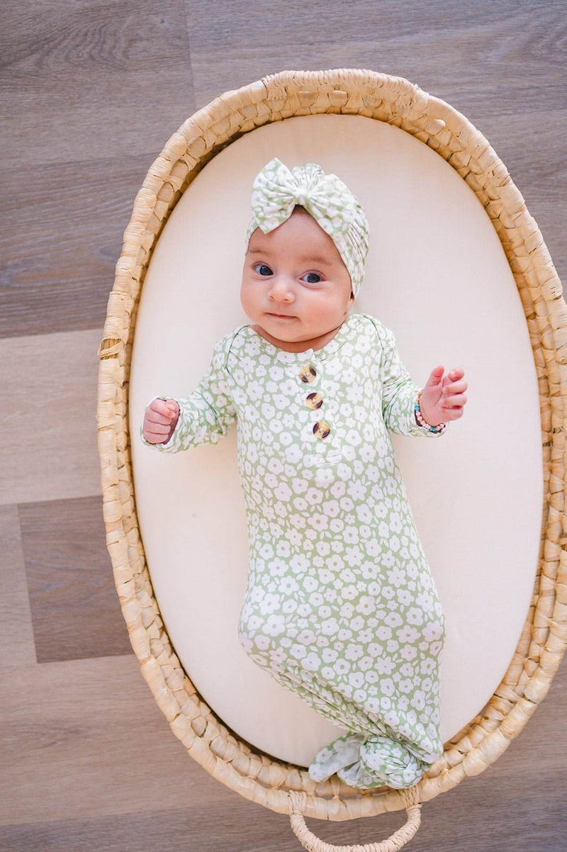 Knotted baby gown in sage ditsy floral pattern, perfect for newborns, made from soft bamboo viscose.