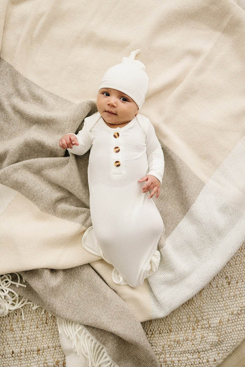 White knotted baby gown made from soft bamboo viscose with fold-over cuffs, suitable for newborns 0-3 months.