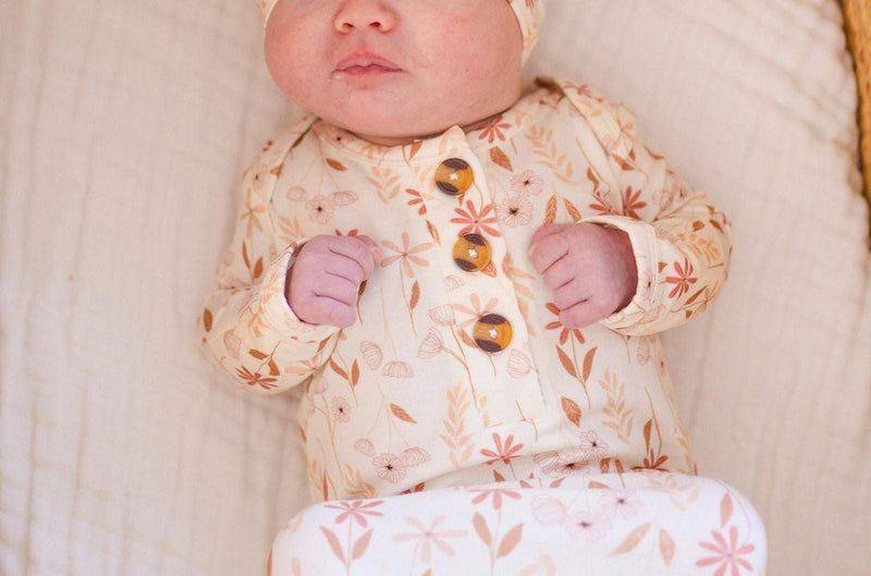 Wildflower bamboo knotted baby gown with buttons and fold over cuffs.