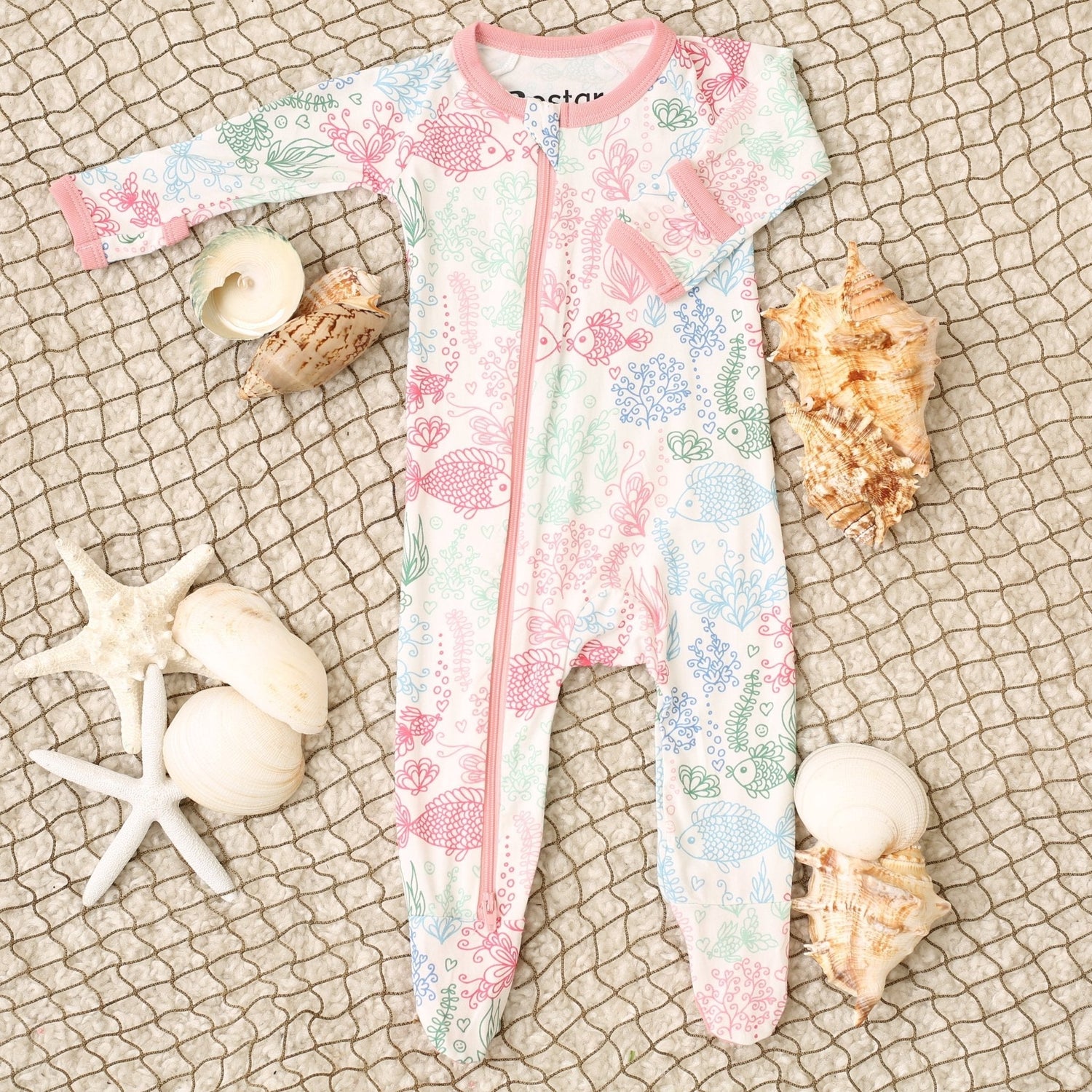 Footie pajamas in pink with a doodled Koi fish print and a full-length two-way zipper.