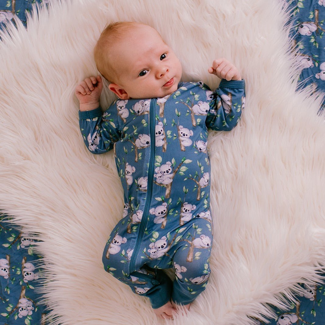 Baby coverall in koala print with a front dual zipper and cuffed ankles.