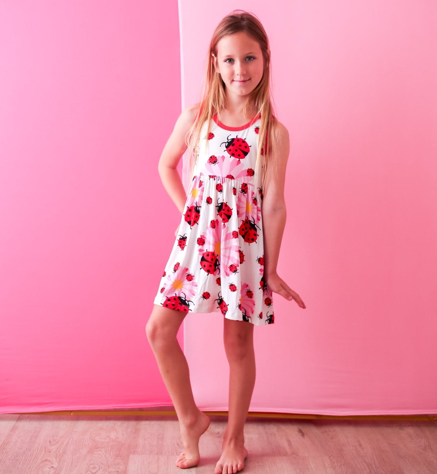 Ladybug-print long-sleeve toddler dress with a full skirt in red and pink tones