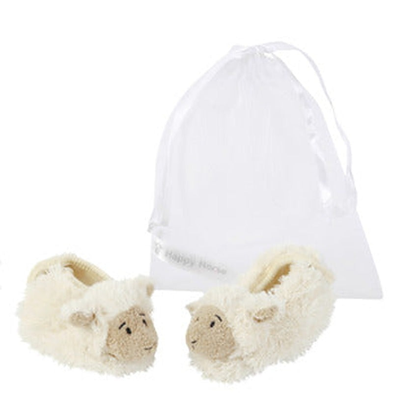 Pair of white lamb-shaped baby slippers presented in a sheer organza gift bag.