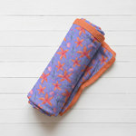 Lavender Leilani print baby swaddle blanket spread out to show the oversized 45-inch square