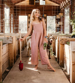 Dusty rose jumpsuit with smocked top, adjustable straps, and a pocket in soft gauze fabric