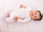 Baby footie pajamas in a pale lemonade clouds print with a full-length front zipper and covered feet.