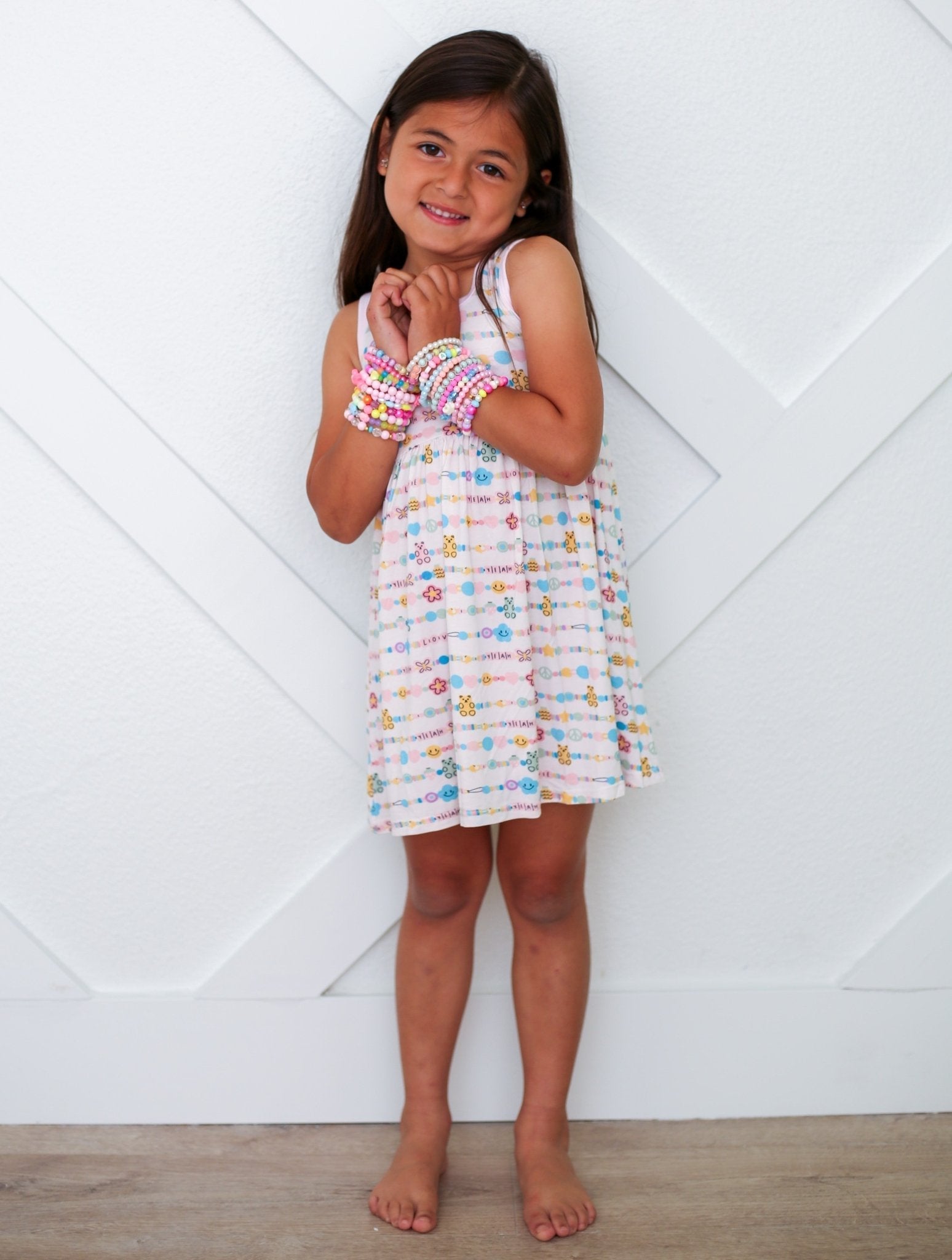 Racerback toddler dress in a pink Let's Be Friends print with short sleeves